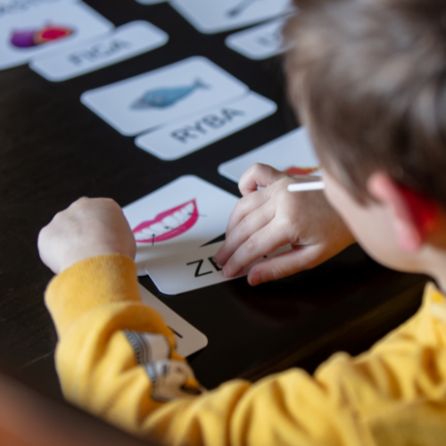 Child looking over flashcards with words and letters