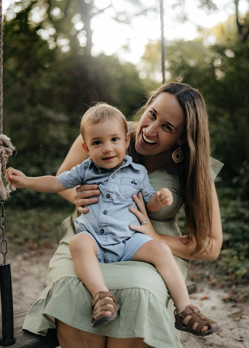 Founder of bAACTalk! Katie Shepherd smiling at the camera with her son